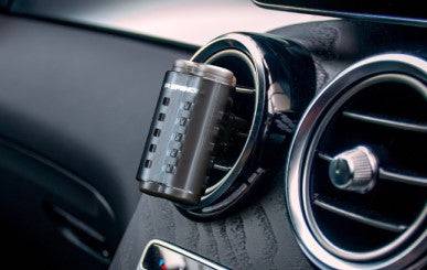 Air Spencer Giga Deux pink vent air freshener mounted in a car vent, showcasing its compact design and vibrant color.