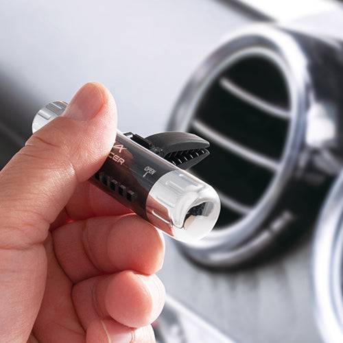 Air Spencer Giga Clip S vent air freshener clip attached to car vent, black plastic design with branding details visible.
