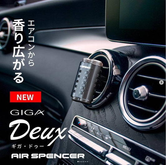 White Lily Air Spencer Giga Deux vent air freshener clipped to car vent with white and silver design elements.