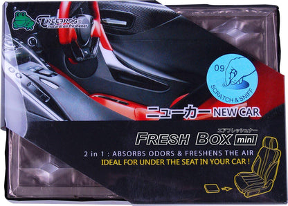 Treefrog Freshbox Mini in a new car interior, compact portable air purifier with modern design and air filter visible.